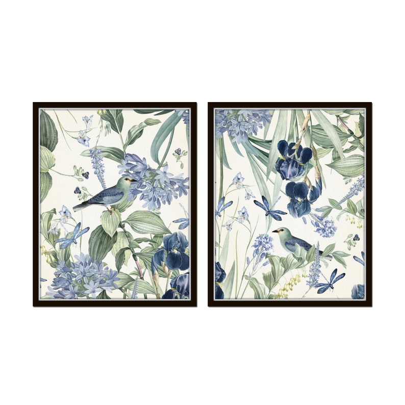 May include: Two framed prints with a botanical theme. The prints feature blue and green flowers, leaves, and birds on a white background.