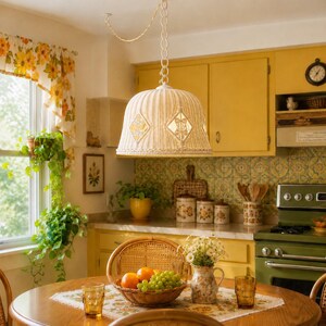 May include: A white woven wicker pendant light fixture with a bell-shaped shade featuring diamond-shaped cutouts, suspended from the ceiling by a white chain and cord in a kitchen setting with yellow cabinets and a wooden dining table.