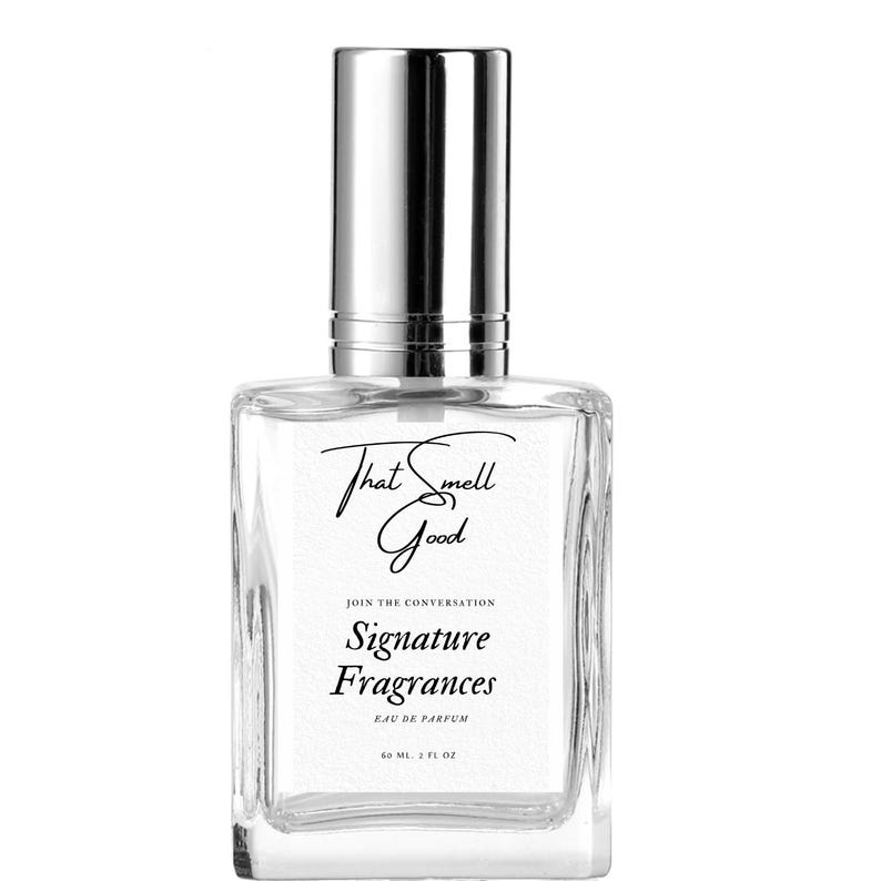 May include: A clear glass perfume bottle with a silver cap. The bottle has the text "That Smell Good" in cursive, and "Signature Fragrances" below it. The bottle contains 2 fl oz of perfume.