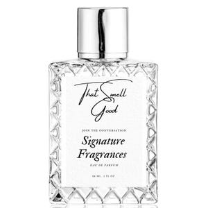 May include: A clear glass perfume bottle with a silver cap. The bottle has a textured design and a white label with the text "That Smell Good" and "Signature Fragrances". The bottle contains 2 fl oz of perfume.