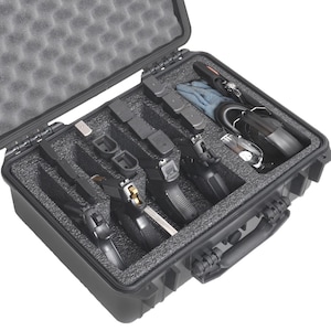 May include: Open black hard case with foam padding, containing several handguns, magazines, gloves, and other accessories. The case is designed for secure storage and transport of firearms and related items.