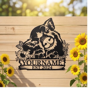 May include: Black metal sign featuring a stylized cat design with sunflowers and the text "YOURNAME EST 2024". The sign is mounted on a wooden background, with yellow sunflowers in the foreground.
