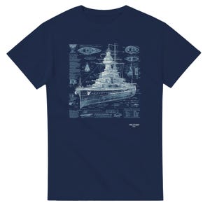May include: Dark blue t-shirt with a light blue blueprint-style illustration of a battleship. The design includes technical drawings and the word "ORCHARD". The shirt has a crew neck.