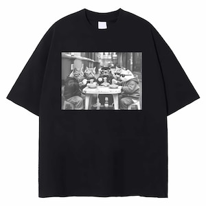 May include: Black t-shirt featuring a black and white image of four cats wearing sunglasses and eating at a table. The cats are dressed in hoodies and jackets, creating a humorous and stylish design. The shirt is made of a soft, comfortable material.