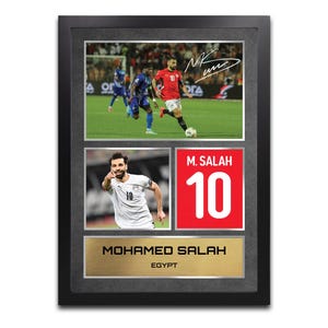 May include: Framed sports memorabilia featuring soccer player Mohamed Salah. The frame includes two action shots of Salah, a jersey graphic with his name and number 10, and a gold plaque with his name and "Egypt".