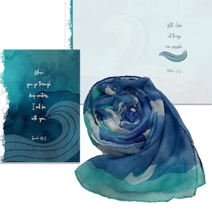 May include: A blue and teal scarf with a watercolor wave design is displayed with two cards. One card has the text "When you go through deep waters, I will be with you. Isaiah 43:2." The other card reads "With God all things are possible. Matthew 19:26."