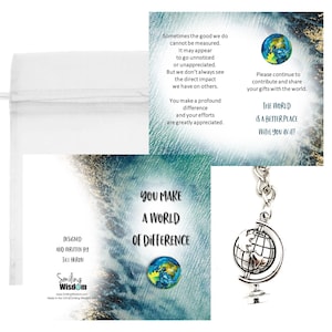 May include: A white drawstring bag next to two greeting cards and a globe keychain. The cards have a blue and gold watercolor background with text that reads "You make a world of difference" and "The world is a better place with you in it!"