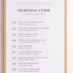 May include: A framed print with a light wood frame. The print features the text "MORNING CODE" and ten principles for the day. The text is in black on a white background. Available in 30x41 and 46x61 cm sizes.