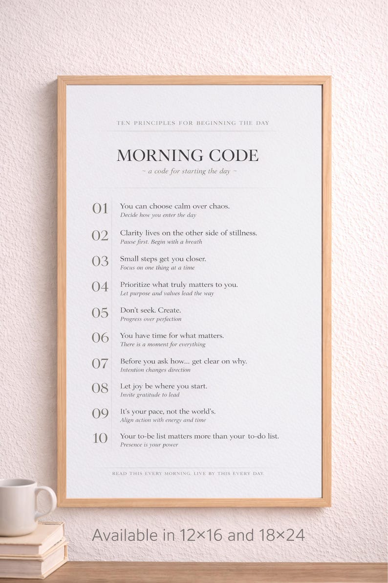 May include: A framed print with a light wood frame. The print features the text "MORNING CODE" and ten principles for the day. The text is in black on a white background. Available in 30x41 and 46x61 cm sizes.