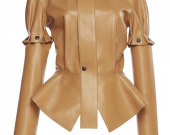May include: A tan-colored leather jacket with a high collar and a peplum waist. The jacket features long sleeves with buttoned cuffs and a button closure down the front. The design is sleek and modern, suitable for various occasions.