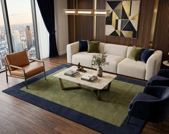 May include: A living room featuring a cream-colored sofa with olive and navy pillows, a tan leather armchair, and two navy blue armchairs. A marble coffee table with gold legs sits on a green and navy rug. A geometric wall art piece hangs above.