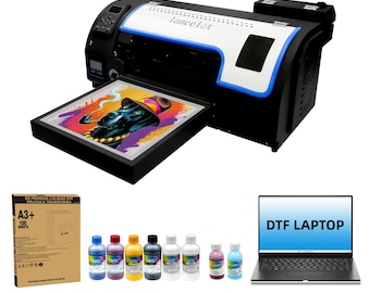 May include: A DTF printer with a black and white design, a laptop with "DTF LAPTOP" text, ink bottles, and a box of A3+ transfer sheets. The printer has a print of a dog wearing a hat and smoking a pipe.