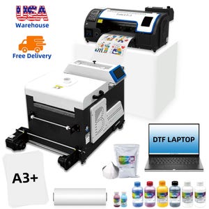 May include: A large black and white DTF printer with a roll of printed paper. The image also shows a laptop with the text "DTF LAPTOP", ink bottles, and A3+ paper.