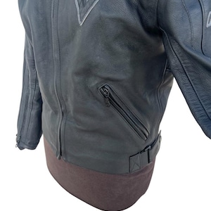 May include: A set of three ceramic mugs with a speckled, matte finish. The mugs are in shades of cream, light gray, and dark gray. Each mug has a simple, minimalist design and a rounded handle. The mugs are likely for coffee or tea.