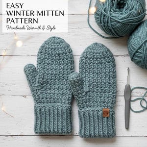 May include: Two teal crocheted mittens with a ribbed cuff, a small brown leather tag, and a crochet hook. The mittens are next to two balls of teal yarn. Text on the left reads "Easy Winter Mitten Pattern Handmade Warmth & Style."