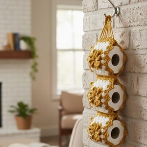 May include: A set of three ceramic mugs with a speckled, matte finish. The mugs are in shades of cream, light brown, and dark brown. Each mug has a simple, minimalist design and a rounded handle.