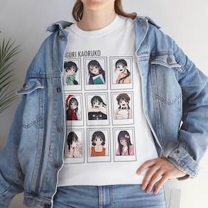 May include: White t-shirt featuring a grid of nine anime-style portraits with the text "AGURI KAORUKO" above. The person is wearing a light blue denim jacket.