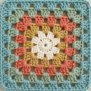 May include: A square crochet granny square featuring a central white flower motif surrounded by concentric layers of yarn in mustard yellow, terracotta orange, sage green, and a dusty blue border, showcasing a classic handmade textile pattern.