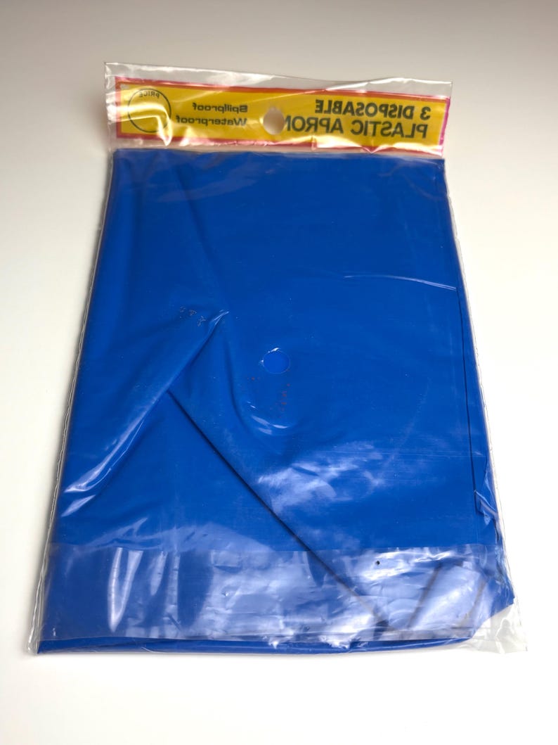 May include: A package containing a folded, bright blue plastic sheet. The sheet is sealed in a clear plastic bag with a yellow and red header that reads "3 DISPOSABLE PLASTIC APRONS".