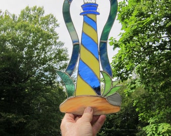 Stained glass Fantasy Island Lighthouse, suncatcher, window hanging. Blue and Yellow. glass. 13.5 inches high by 7 wide.