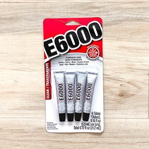 May include: A package of four 0.18 oz tubes of E6000 clear adhesive. The package is red and white with the product name and instructions. The tubes are silver with black caps.