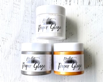 May include: Three small jars of white, silver, and gold paint labelled "Perfect Paper Glaze".