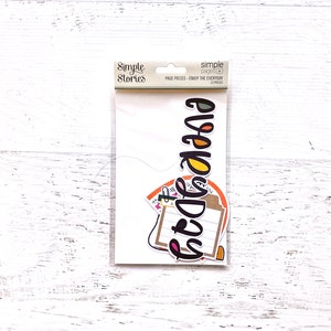 May include: A pack of colorful paper stickers with the word "GRAD" in large letters. The stickers are designed for scrapbooking and crafting. The pack is from Simple Stories.