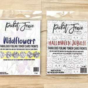 May include: Two packages of foiling toner card fronts, one with a floral design and the text "Wildflowers" and the other with a pumpkin design and the text "Halloween Jubilee". Both packages are labeled "Fabulous Foiling Toner Card Fronts" and include the text "Made in the USA" and "Not for use with children".
