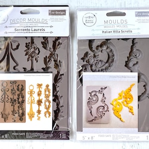 Puede incluir: Dos moldes de silicona para manualidades. El molde de la izquierda está etiquetado como "Sorrento Laurels" y presenta un diseño de hojas de laurel y lazos. El molde de la derecha está etiquetado como "Italian Villa Scrolls" y presenta un diseño de volutas ornamentadas. Ambos moldes miden 5 pulgadas por 8 pulgadas y son aptos para alimentos.