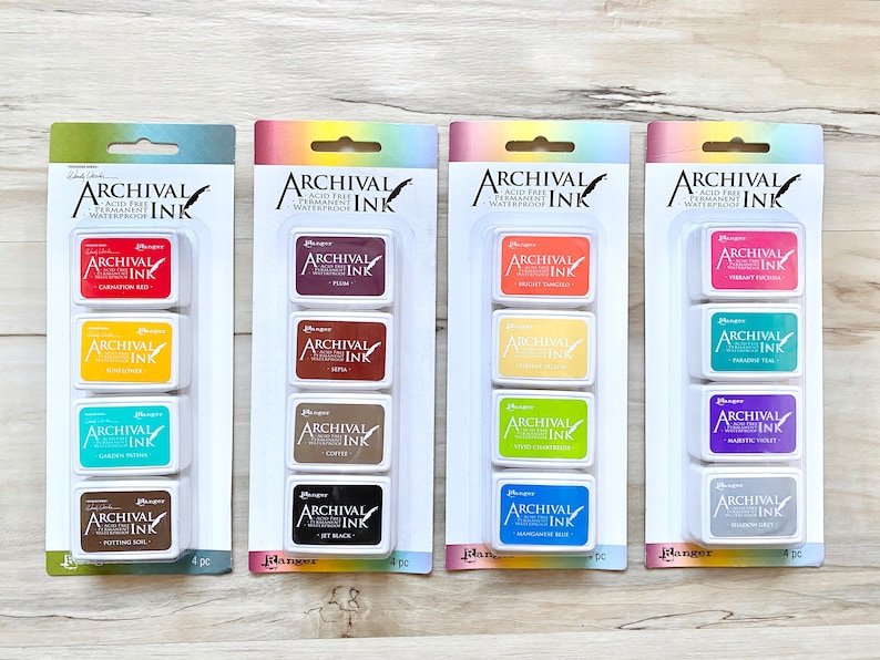 May include: Four sets of four archival ink pads in different colors. Each set includes carnation red, sunflower, turquoise, potting soil, plum, sepia, coffee, jet black, bright apricot, spring green, coral, mango tango, vibrant fuchsia, paradise teal, royal violet, shadow grey, and manganese blue.