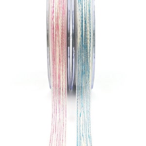 May include: Two spools of ribbon, one pink and one blue, with a white background. The ribbon is thin and has a shimmery finish.