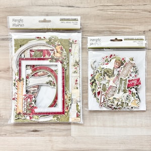 May include: Two packages of Simple Stories chipboard embellishments for scrapbooking and paper crafting. The first package contains frames with the text "merry & bright". The second package contains clusters with the text "dashing through", "holiday", and "dear's".
