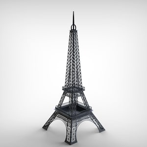 Pode incluir: Um modelo cinza escuro da Torre Eiffel. A torre &eacute; uma r&eacute;plica detalhada do ic&oacute;nico monumento parisiense, com intrincados trabalhos de treli&ccedil;a e uma agulha pontiaguda. O modelo est&aacute; sobre um fundo branco.