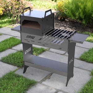 May include: A dark gray outdoor grill with a pizza oven, side shelves, and a lower storage shelf. The grill has a metal grate and the word "BBQ" is cut out on the side. The grill is on a stone patio with grass.