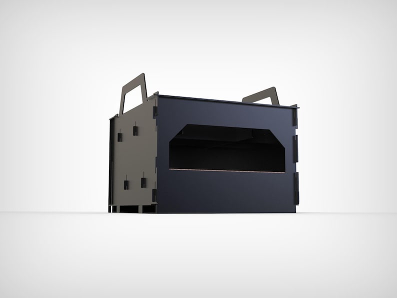 May include: A dark gray and black rectangular box with two handles on top. The box has a large rectangular opening in the front and several small rectangular cutouts on the sides. The box appears to be made of metal.