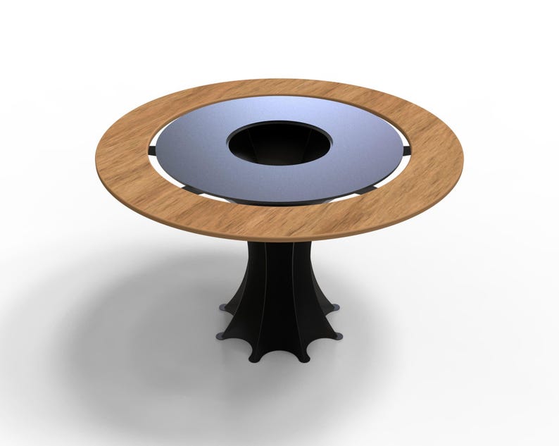 May include: A round table with a light brown wooden rim and a dark gray center. The table has a black, stylized pedestal base. The table's diameter is approximately 40 inches.