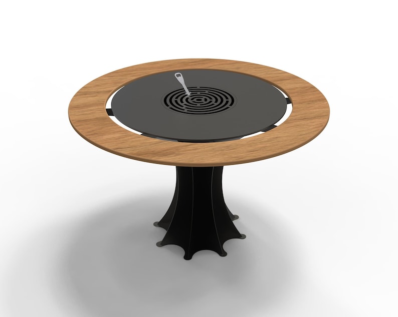 May include: A round outdoor grill table with a wooden rim and a black metal center. The table has a black, stylized base. A small, silver utensil rests on the grill surface.