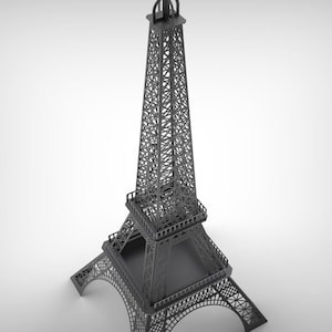 Pode incluir: Um modelo cinzento da Torre Eiffel, uma r&eacute;plica em miniatura do ic&oacute;nico monumento parisiense. A torre apresenta intrincados trabalhos de treli&ccedil;a e detalhes arquitet&oacute;nicos, com uma base quadrada e um topo pontiagudo. Um item decorativo.
