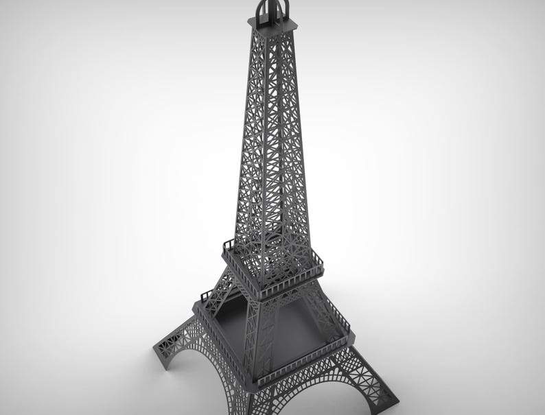 Pode incluir: Um modelo cinzento da Torre Eiffel, uma r&eacute;plica em miniatura do ic&oacute;nico monumento parisiense. A torre apresenta intrincados trabalhos de treli&ccedil;a e detalhes arquitet&oacute;nicos, com uma base quadrada e um topo pontiagudo. Um item decorativo.