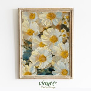 Pode incluir: Impressão floral emoldurada com margaridas brancas e centros amarelos. A pintura tem uma estética vintage, com pinceladas visíveis e uma paleta de cores suaves. A moldura é de cor clara e neutra.