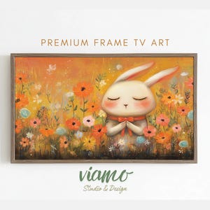 Pode incluir: Uma obra de arte emoldurada com um coelho sereno de olhos fechados, usando um cachecol vermelho, em meio a um campo de flores coloridas. A obra de arte tem um fundo quente e dourado com o texto "PREMIUM FRAME TV ART" no topo.