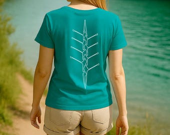 May include: Teal t-shirt with a white rowing graphic on the back. The shirt features the text "Suivez la ligne..." at the bottom. The image also includes the "ROWING Natural" logo in the upper right corner.