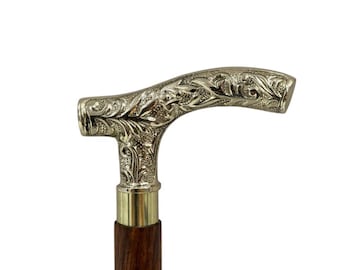 May include: A silver-colored walking cane with an ornate floral design on the handle. The handle is connected to a brass collar and a dark brown wooden shaft. The cane is a classic accessory.