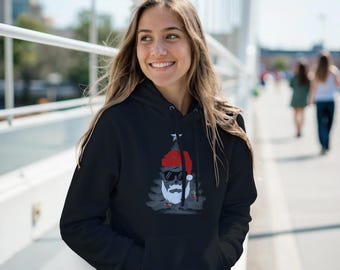 May include: Black hooded sweatshirt featuring a graphic of Santa Claus wearing sunglasses and a red hat. The design includes a white beard and a star above the hat. The sweatshirt has a front pocket and a drawstring hood.