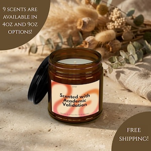 May include: A brown glass jar candle with a black lid, labeled "Scented with Academic Validation." The label has a gradient of orange and pink. The text "9 scents are available in 4oz and 9oz options!" is also visible.