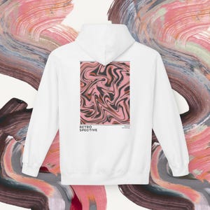 May include: White hoodie with a retro-style design. The back features a rectangular graphic with a swirling pattern in shades of pink, black, and brown. The word "RETROSPECTIVE" is printed below the graphic.