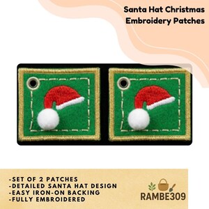 May include: Two square green embroidery patches featuring a red and white Santa hat design with a white pom-pom. Each patch has a gold-colored border, a metal eyelet in the top left corner, and a white stitched square frame detail.