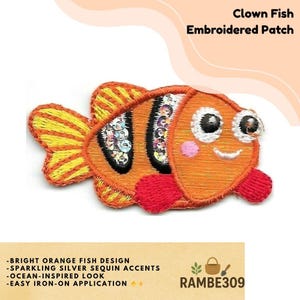 May include: Embroidered patch featuring a bright orange clown fish design with sparkling silver sequin accents. The patch has an ocean-inspired look and is easy to iron on. The text "Clown Fish Embroidered Patch" is at the top. The seller's name is "RAMBE309".