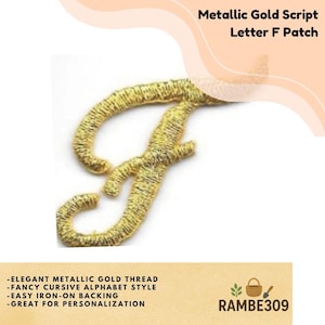 May include: A metallic gold embroidered patch in the shape of the cursive letter F. The patch features a textured surface created by dense gold thread stitching. The text Metallic Gold Script Letter F Patch is visible at the top of the image.