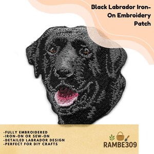 May include: An embroidered patch featuring the head of a black Labrador dog with brown eyes and an open mouth showing a pink tongue. The text Black Labrador Iron-On Embroidery Patch is visible in the upper right corner of the image.